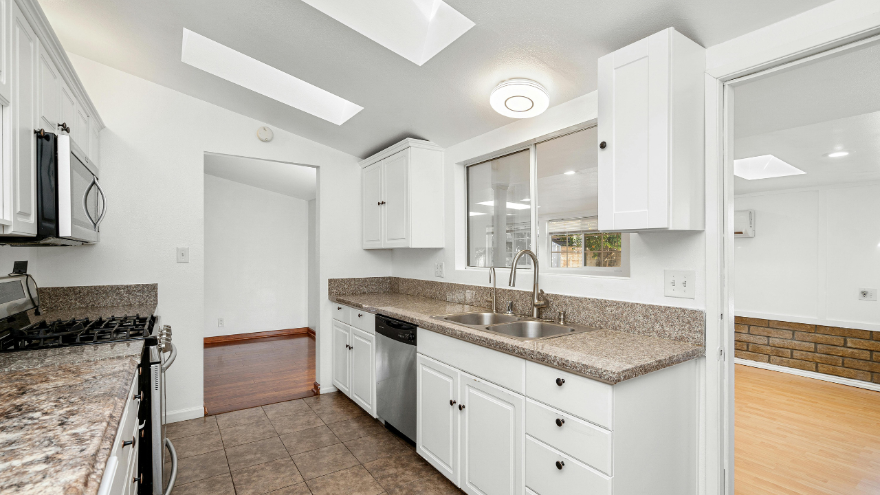 Wall sconces providing ambient lighting for hallways in a remodeled home